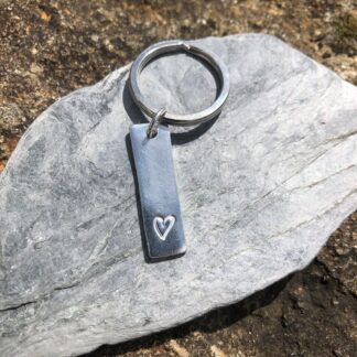 Silver keyring with a heart at the bottom and a large split ring