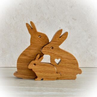 Handcrafted wooden rabbit family of three with heart cut-out detail