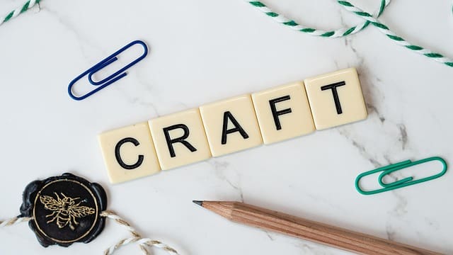 The word 'Craft' with some string, a pencil, and paperclip