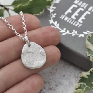 Organic Argentium sterling silver pendant hand forged from molten silver off cuts and pressed between two charcoal blocks to provide a unique slate-like surface texture