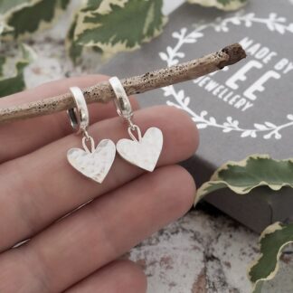 Solid silver 13mm wide hearts suspended from silver leverback huggie-style hoop earrings