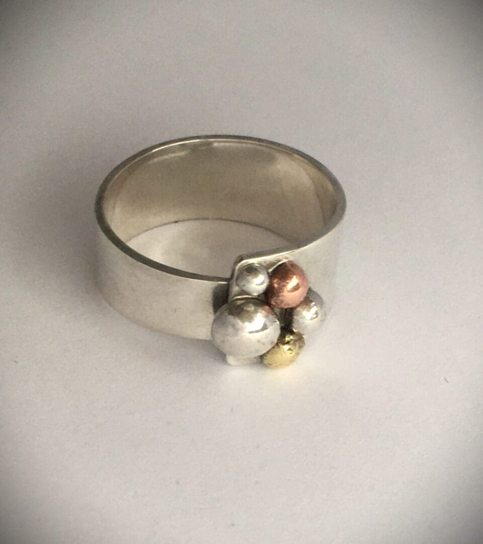 Silver copper and brass pebble ring