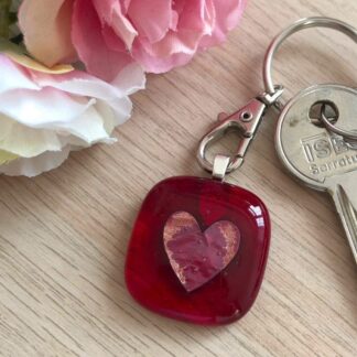 Bright red translucent fused glass keyring with a copper coloured heart in the centre