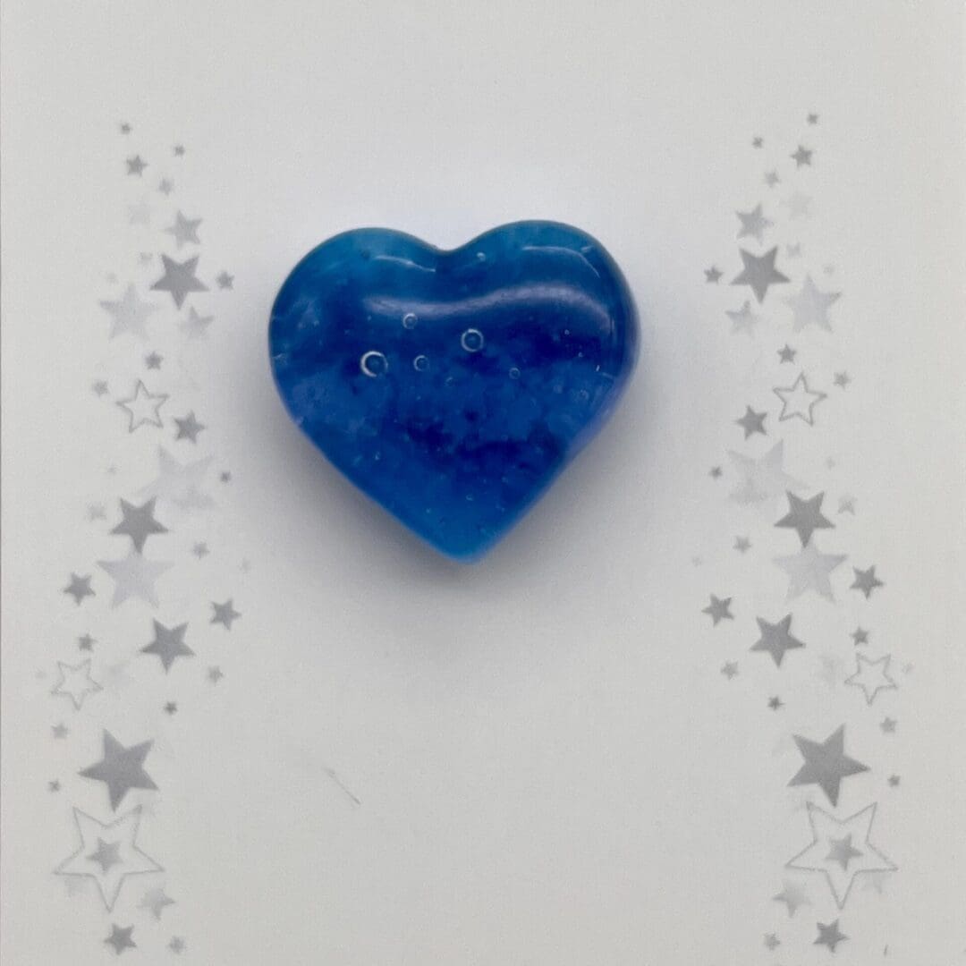 Close up of shades of blue heart shaped pin brooch