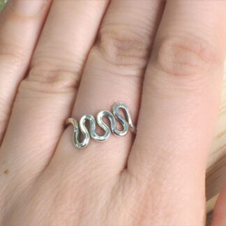 Sterling silver wave ring shown on finger