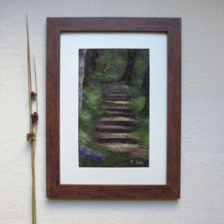 A dark woodland pathway with steps climbing up through the trees. Sunlight shines on the steps and there is a smattering of bluebells in the undergrowth.