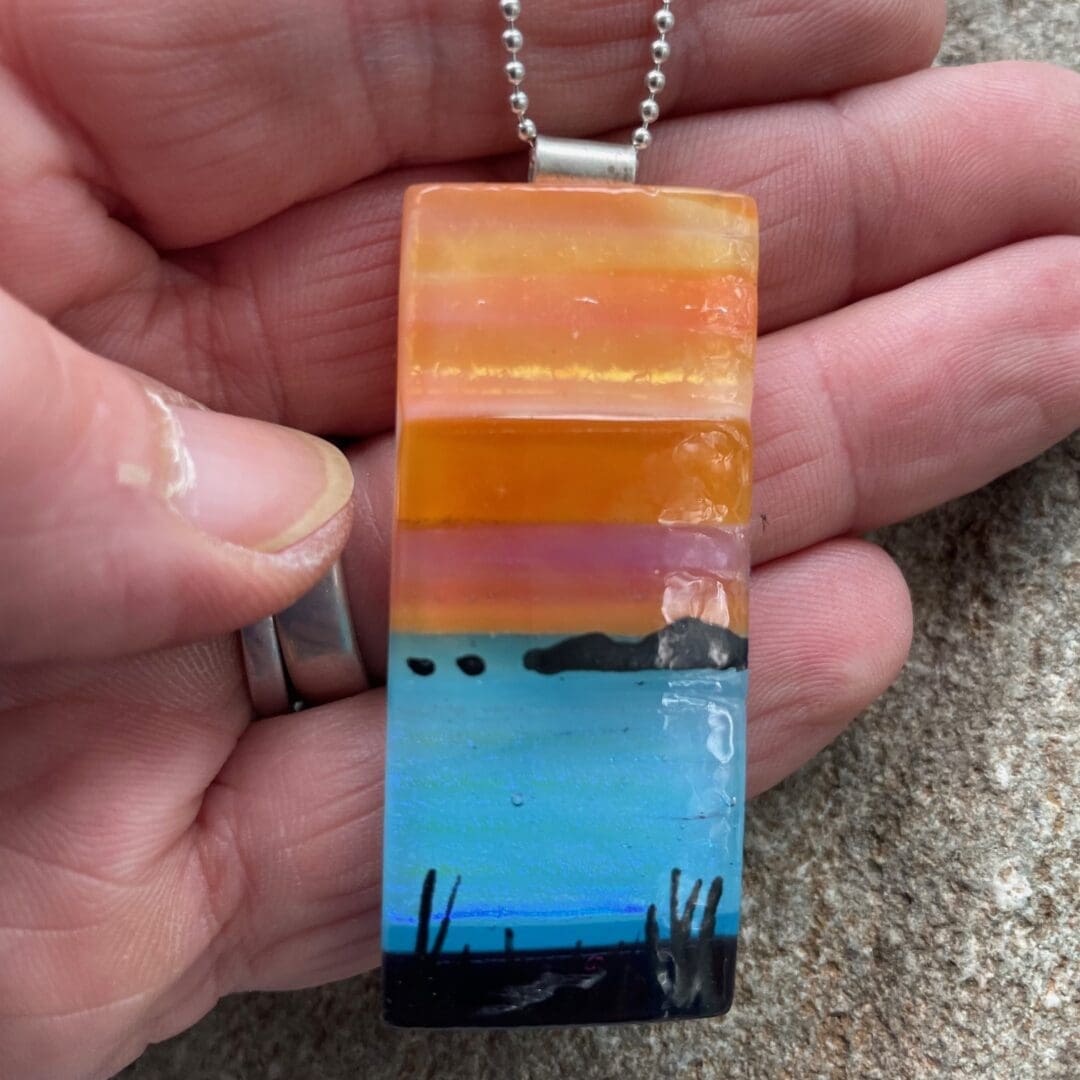 glass pendant with sunset over the sea