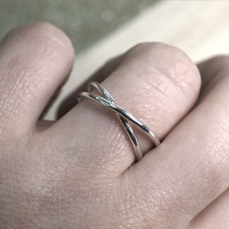 Sterling silver rolling ring shown on finger