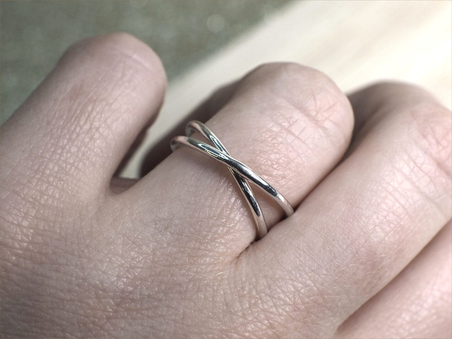 Sterling silver rolling ring shown on finger