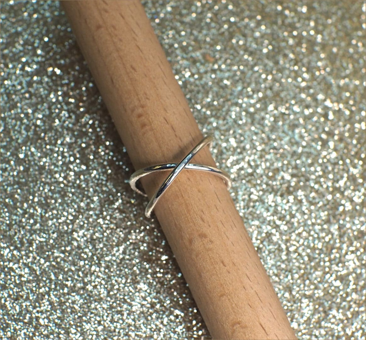Sterling silver rolling ring shown open on stand