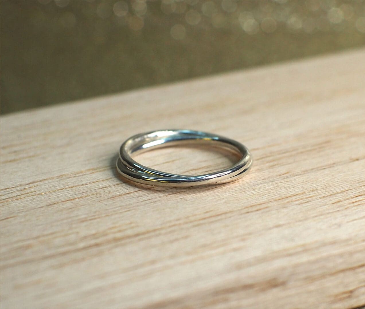 Sterling silver rolling ring shown on table