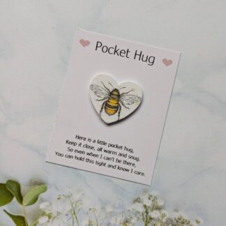 Small white wooden heart decoupaged with a bee design and mounted on a card with message