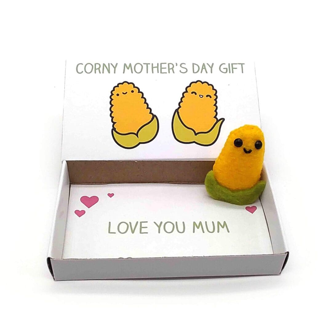 Cute Mother's Day gift. A handmade happy corn cob in an illustrated matchbox that reads Corny Mother's Day gift on the outside and Love you Mum on the inside