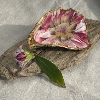 A handmade decoupaged oyster featuring a lovely pretty pink flower.