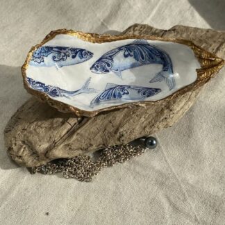 A handmade decoupaged oyster featuring lovely pretty blue fish.