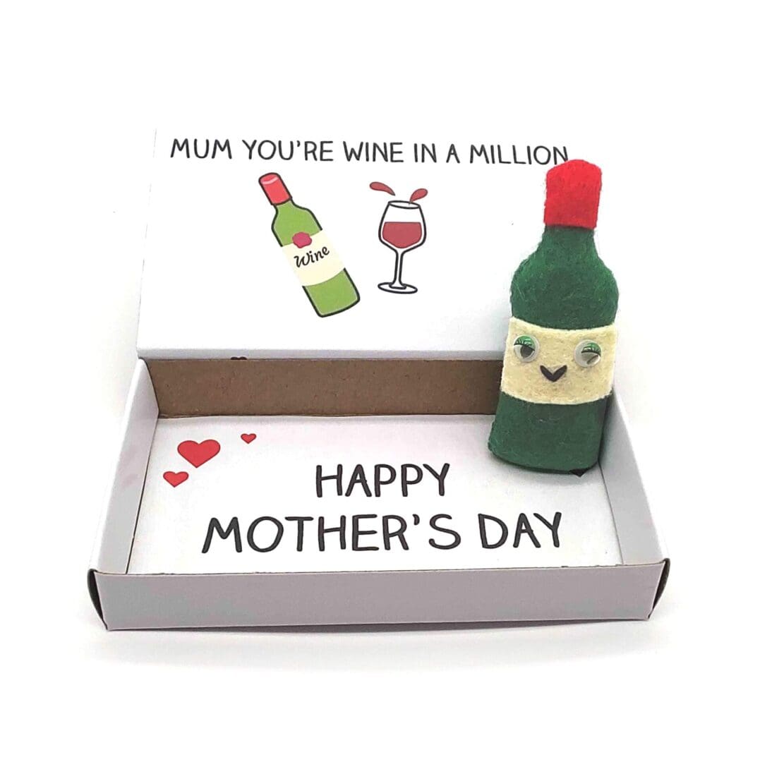 A cute handmade mother's day gift. A smiley felt bottle of wine magnet in an illustrated match box which reads you're wine in a million on the outside and happy mother's day on the inside
