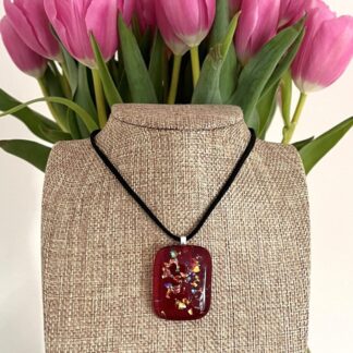 Handmade translucent red fused glass necklace with sparkly rainbow pieces