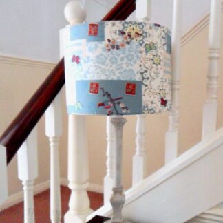 A drum lampshade with a birds and butterflies design