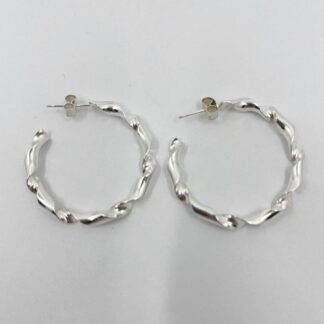 Sterling silver hoop earrings on a white background. The hoops feature a twisted wire design and have a post and butterfly scroll fittings, to pass through the earlobe.