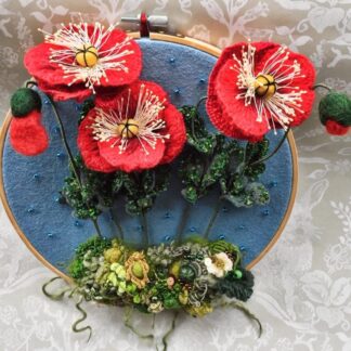 Stumpwork embroidered poppies on a 10" embroidery hoop.