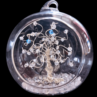 A silver wire tree set into an 8cm open fronted glass baubles. The branches are decorated with clear crystals and have two birthstone drop crystals hanging from the branches in aquamarine and sapphire.