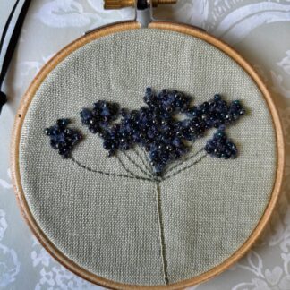 Black and grey beaded Cow parsley on a 4" embroidery hoop.