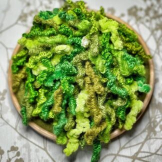 An Embroidery of long Curly tendrils of moss in shades of green, sewn on a 5" embroidery hoop.