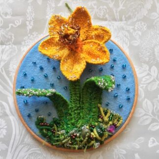 An embroidered stumpwork Daffodil mounted on a 6" embroidery hoop