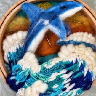 A Felted Dolphin in the waves mounted on a 7" dia & 24mm thick embroidery hoop