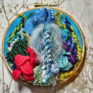 A 3d felted Jelly fish mounted on a 5" embroidery Hoop