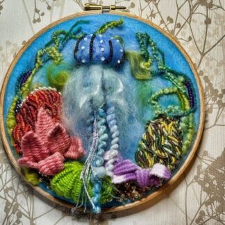 A 3d felted Jelly fish mounted on a 7" embroidery Hoop