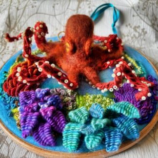 A 3d felted Octopus mounted on a 8” Embroidery Hoop