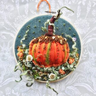 Orange felt Pumpkin on a 7" embroidery hoop