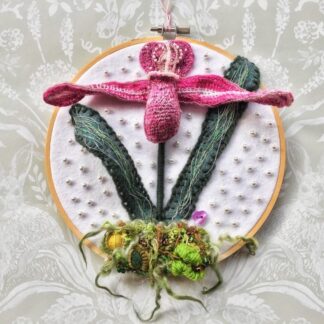 An embroidered stumpwork Slipper Orchid mounted on a 7" embroidery hoop.