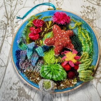 A 3d stumpwork weaved Starfish mounted on a 8” Embroidery Hoop