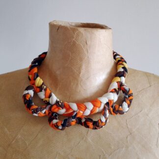 chunky bib necklace made from recycled fabrics in orange, black and white