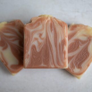 dark pink and white soap bars arrange one on top of the other