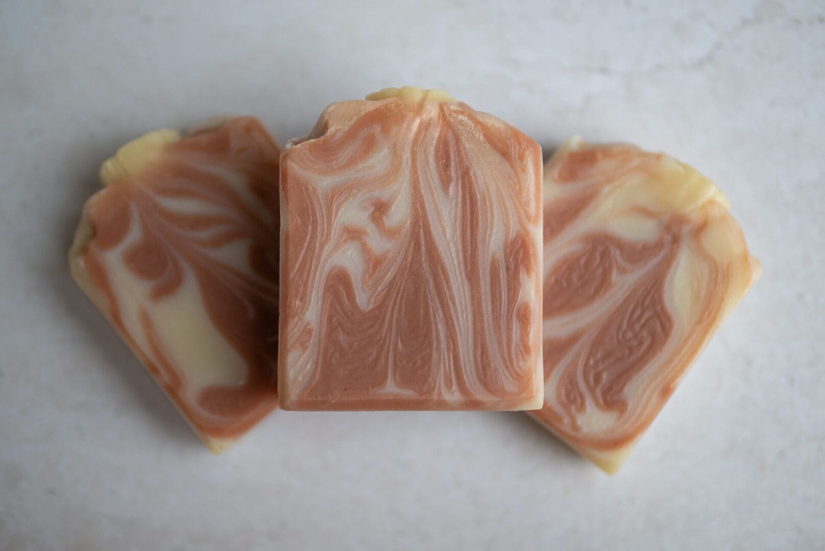 dark pink and white soap bars arrange one on top of the other