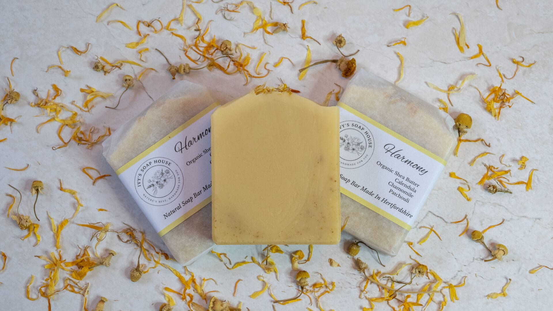 Yellow soap bars sitting on a bed of yellow calendula flower petals