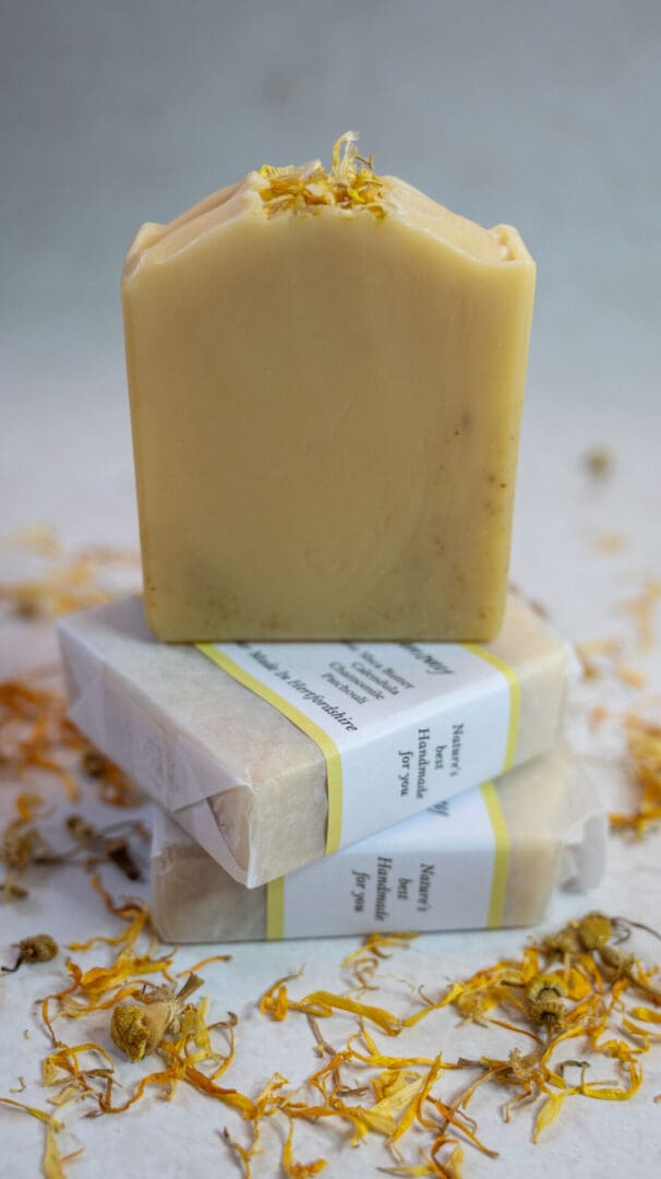 Yellow soap bars sitting on a bed of yellow calendula flower petals