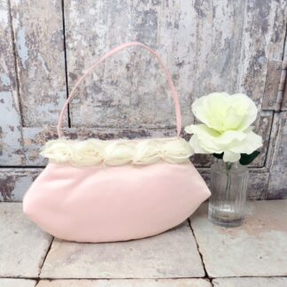 Pink satin flower girl or bridesmaid bag with an ivory rosette trim.