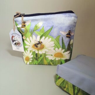 Daisy And Bee make up purse with a pale blue cotton reverse, chunky zipper and daisy charm zip pull