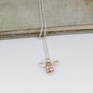 Silver bee necklace with copper stripes