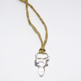 Silver arrowhead pendant on silk cord