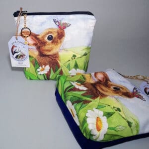 Rabbit and butterfly make up purse with a blue cotton reverse, chunky zipper and daisy charm zip pull