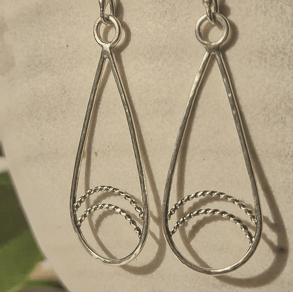 Closeup of the twisted wire detailing in the teardrop earrings.