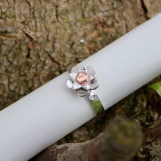 Silver flower ring with copper centre