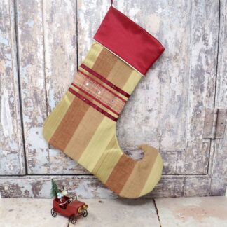Red and gold Christmas stocking with a red satin cuff and ribbon hanging loop.
