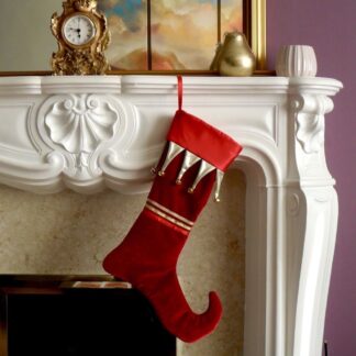 A luxury red velvet Christmas stocking with a red satin cuff and gold coloured bells.