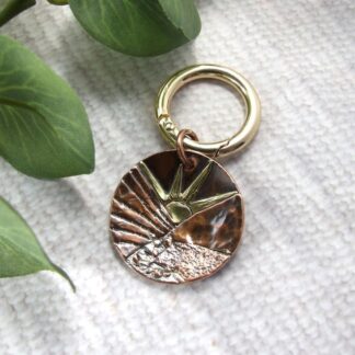 rising sun copper bag charm